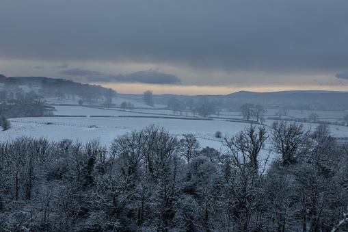 Frosty, fresh snowfall covering fields and trees in the ribble valley