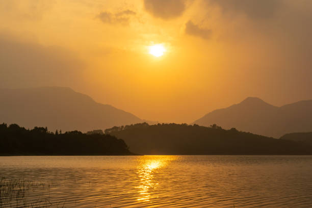 istock The setting sun dyed the sky and the lake yellow, 1338870084