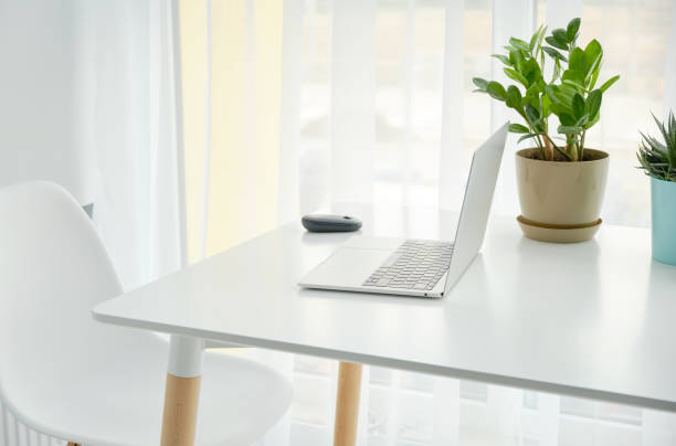 istock Workplace with notebook laptop Comfortable work table in office windows and city view. 1338870532