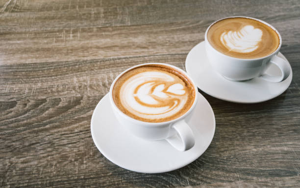 istock White coffee two cup latte on wooden table in a coffee shop, with empty space for text. Concept drink for relaxation. 1338871165