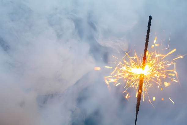 istock abstract Christmas sparkler firework background with smoke 1338871936