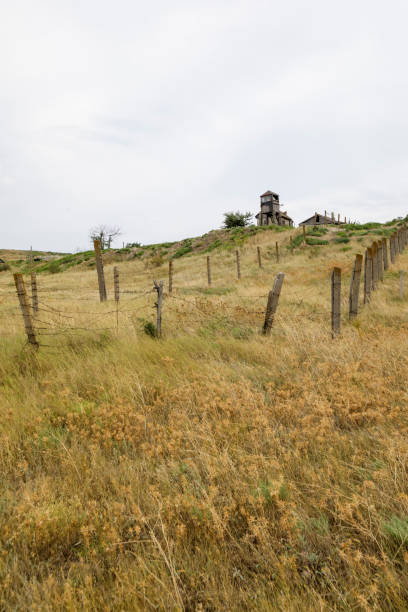 istock Abandoned buildings fenced with rusty barbed wire 1338873837