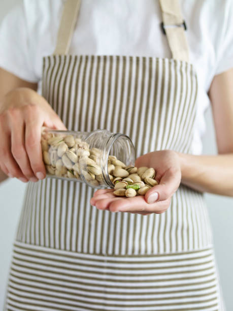 holding pistachios - dieting front view vertical lifestyles imagens e fotografias de stock