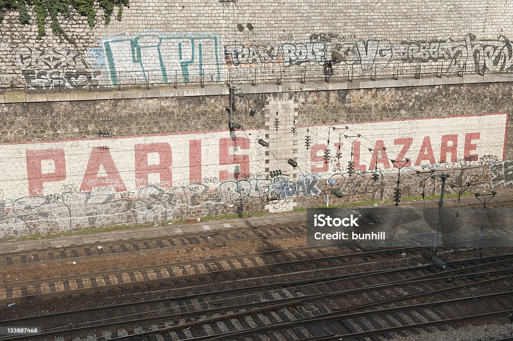 Paris - sign on the approach to Gare St Lazare Approach to Gare St Lazare (Paris, France) - old sign painted on a wall by railway track. Warm late afternoon light. Capital Cities Stock Photo