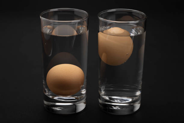 istock Eggs in water test on transparent glass , Egg freshness test on black background , Bad egg floats in water 1338874688