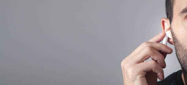 istock Caucasian man wearing white wireless earphone. 1338875934