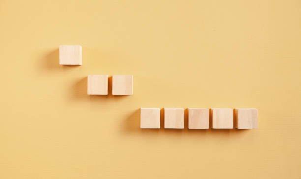 istock Wooden cubes on the yellow background. 1338875968