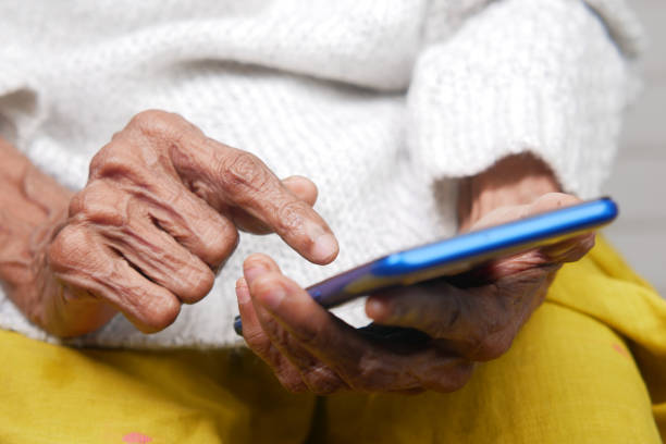 istock senior women hand using smart phone close up 1338877415