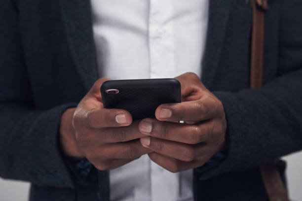 istock Studio shot of an unrecognisable businessman using a smartphone against a grey background 1338878322