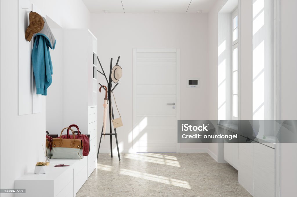 Front Door Entrance To House With White Cabinets And Coat Hanger In Corridor. Entrance Hall Stock Photo