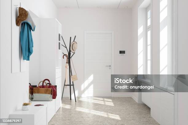 Front Door Entrance To House With White Cabinets And Coat Hanger In Corridor Stock Photo - Download Image Now