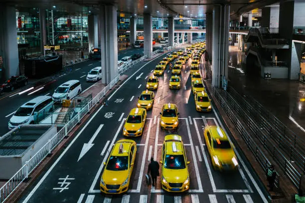 Busy Yellow Taxi Queues at Taxi Service Point, People using public transportation from the airport / Chongqing, China