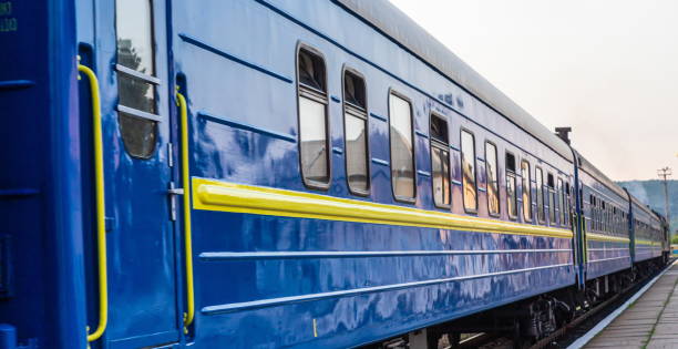 istock a blue passenger train travels along the track 1338880871