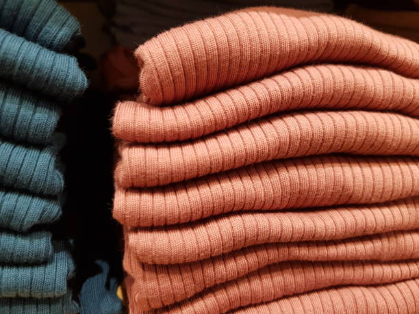 istock Stack of knitted wear on display on rack 1338882371