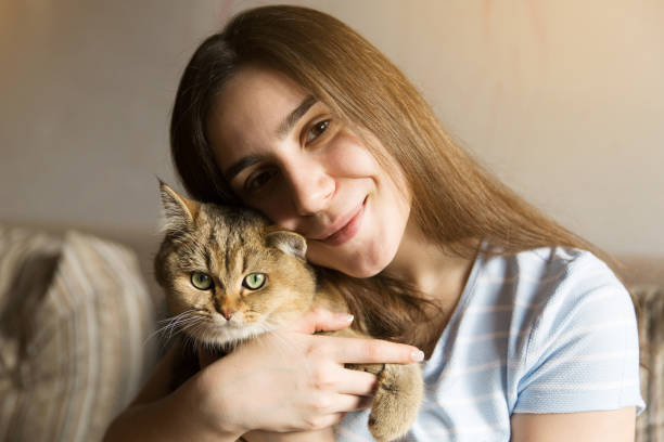 istock Cute girl sitting hugging a purebred cat 1338882668