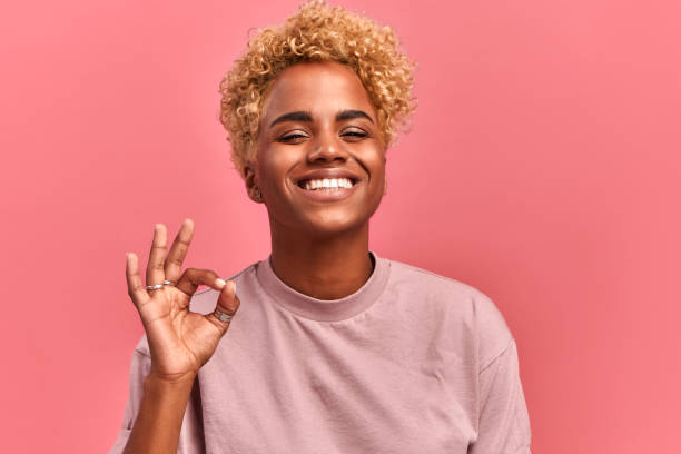 istock Gesture everything ok. Smiling black woman has all under control, gives positive reply 1338882747