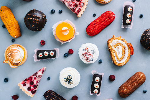 Assortment of confectionery, different types of cakes and desserts on the table.