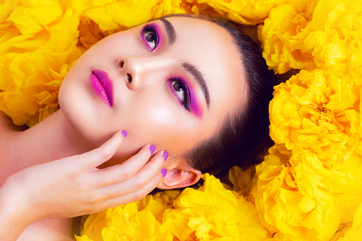 Colorful fashion makeup Asian woman  with yellow flower.
