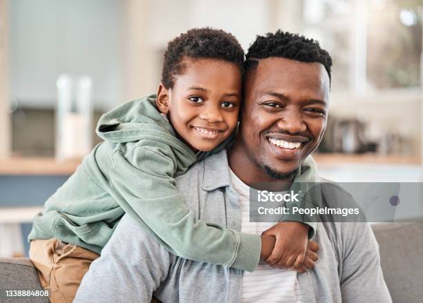 Shot Of An Adorable Little Boy Spending Quality Time With His Father On The Sofa At Home Stock Photo - Download Image Now