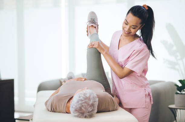 Shot of an older woman doing light exercises during a session with a physiotherapist inside The gift of apathy physical therapy stock pictures, royalty-free photos & images