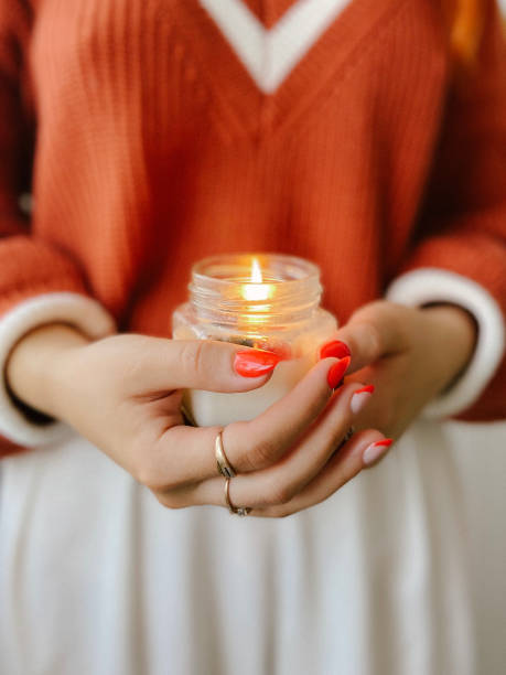 istock Image of a candle in hands. Cosiness 1338888914