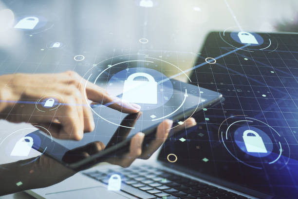 istock Double exposure of creative lock hologram with chip and with finger clicks on a digital tablet on background. Information security concept 1338891149