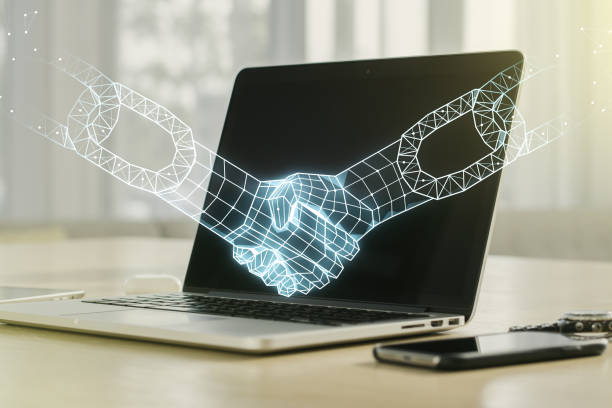 istock Creative concept of blockchain technology with handshake on modern laptop background. digital money transfers and decentralization concept. Multiexposure 1338891171