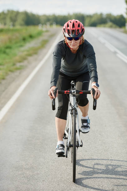 istock Female racing cyclist on a road bike 1338892421