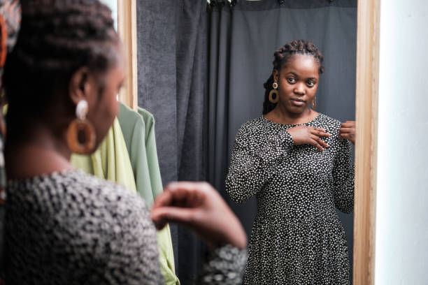 istock Woman trying on new dress 1338894591