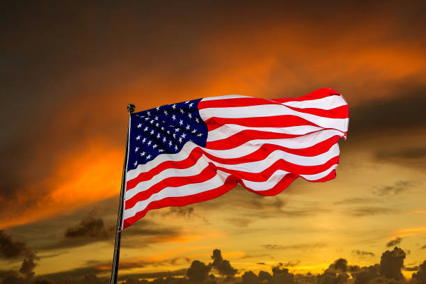 istock USA flag waving against sunset sky 1338895628