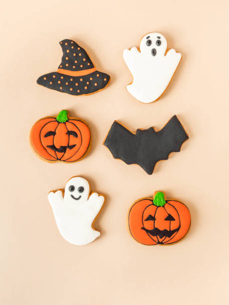 istock Various Halloween gingerbread cookies - Jack O'Lanterns, ghosts, bat and black hat on beige background. 1338895899