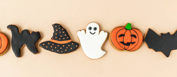 istock Various Halloween gingerbread cookies - Jack O'Lanterns, ghosts, bat and black hat on beige background. Banner 1338895903