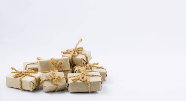 istock brown gift on a white background,Stack of handcraft gift boxes on white background 1338896093