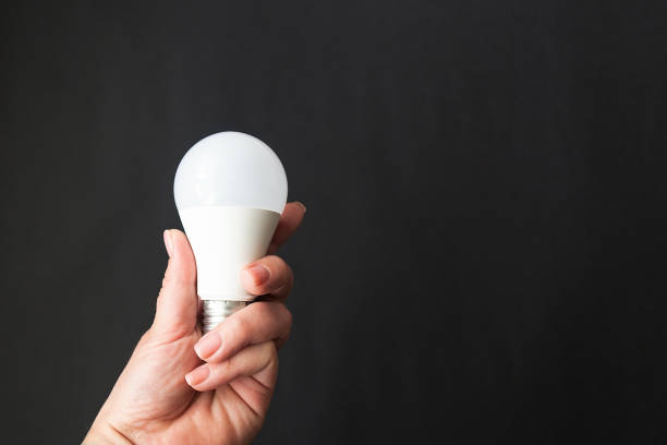 istock light bulb in hand on a black background 1338898650