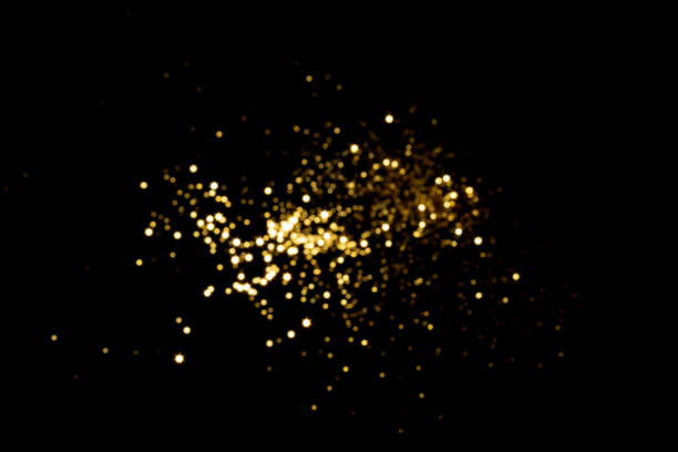 istock Golden blurred bokeh lights on black background 1338899306
