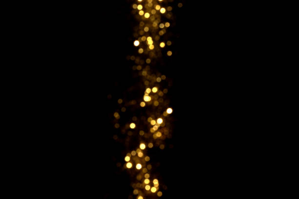 istock Golden blurred bokeh lights on black background 1338899312