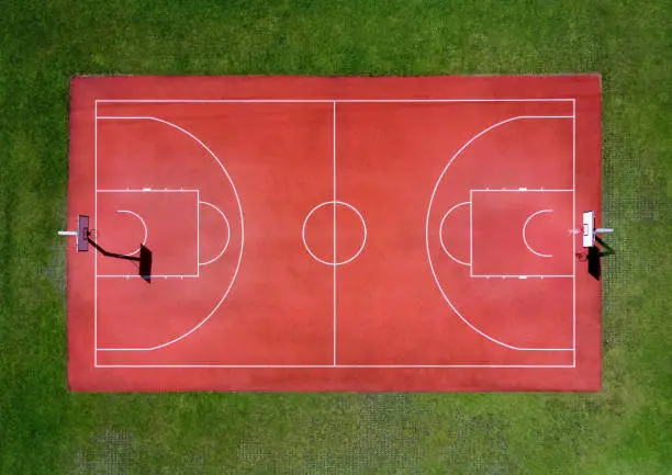 Photo of Red basketball court with marking lines