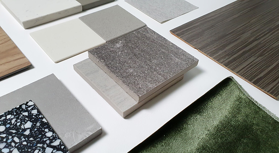 samples of interior material consists concrete tile, wooden laminated or veneer, artificial stones, green fabric for drapery, wooden vinyl flooring. interior selected material for mood and tone board.