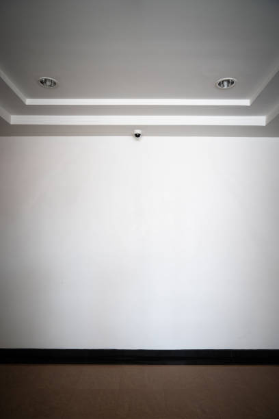 istock CCTV camera is installed in front of the empty backdrop wall on the ceiling  for monitoring and running safety system control in that area. 1338901331