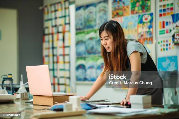 Asian Chinese Female Smiling Teacher Teaching Online Art Class At Art School Stock Photo - Download Image Now