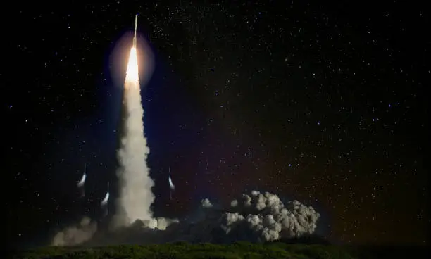 Photo of Missile launch at night. Elements of this image furnished by NASA.