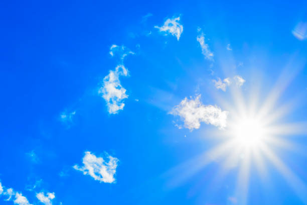 istock Bright sun with beautiful beams in the sky with light clouds 1338901907
