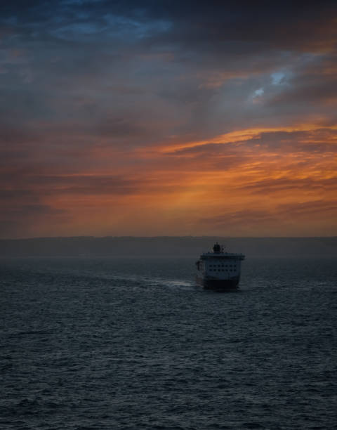 Large tanker ship cruising off the English Channel waters as the sun starts to set.