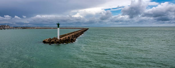 istock Breakwater with lighthouse on French coast 1338903350