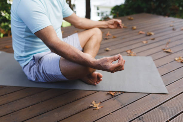 istock Relaxed senior caucasian man practicing yoga, meditating in garden 1338903453