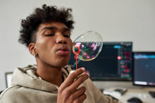 istock Ethnic man blow soap bubbles relax at home 1338904490