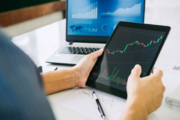 istock businessman working on project for analyzing company financial report balance statement with documents graphics at modern office space. Concept picture of business,economy, market,money and tax. 1338905336