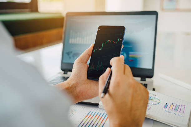 istock businessman working on project for analyzing company financial report balance statement with documents graphics at modern office space. Concept picture of business,economy, market,money and tax. 1338905350