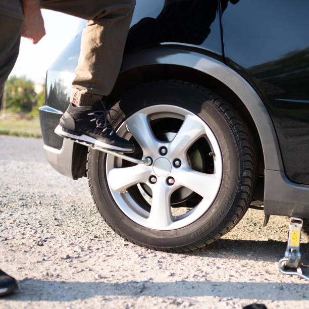 istock changing tire on the road closeup 1338906816