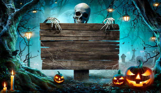 halloween party card - pumpkins and skeleton in graveyard at night with wooden board - halloween stok fotoğraflar ve resimler